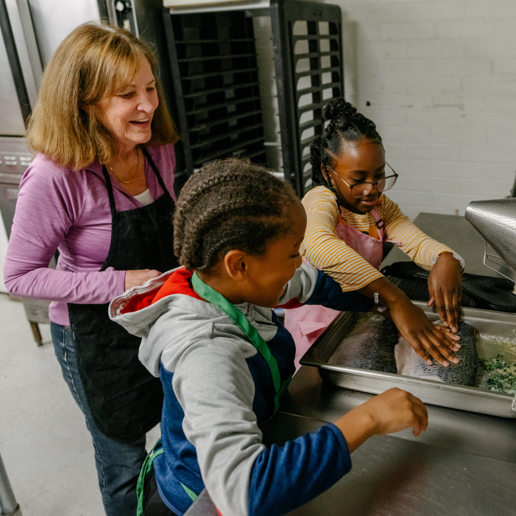 volunteer teaching kids to cook